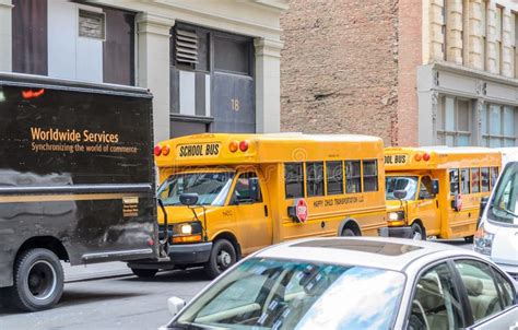 Two Yellow School Buses Parked In A Row In A Manhattan Neighborhood