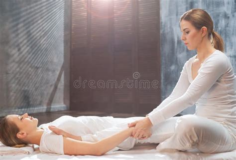 Professional Masseur Doing Thai Massage Therapist Is Making Body Stretching Exercises To The