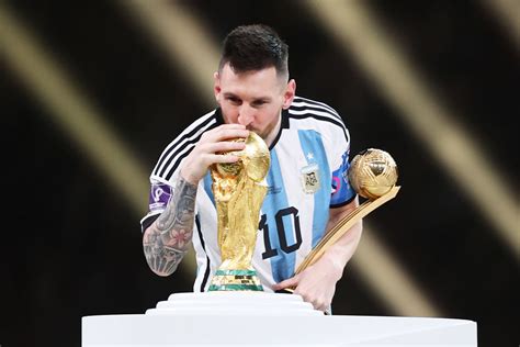Lionel Messi Kisses His Trophy While Celebrating Win At Fifa World Cup