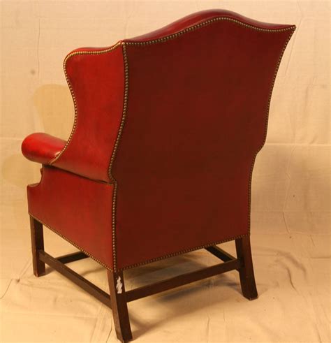 Back legs are moderately carved with a dramatic rake. Single Wing Back Red Leather Chair at 1stdibs