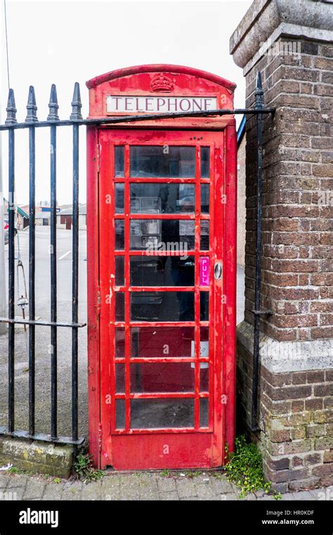 Traditional Red Public Telephone Box Kiosk On A Street In England Uk