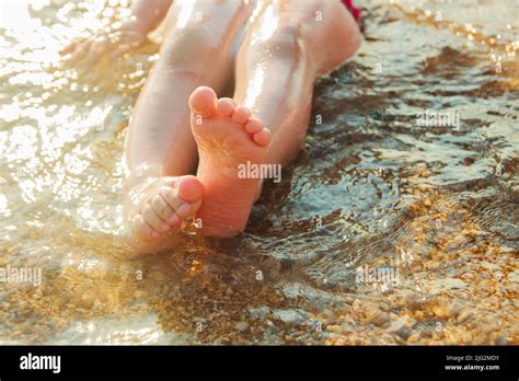 Kids Feet On The Beach In The Water Stock Photo Alamy