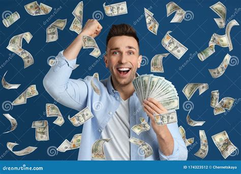 Happy Young Man With Dollars Under Money Rain On Background Stock Photo