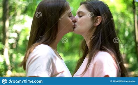Two Pretty Lesbians Girlfriends Kissing And Hugging In A Cozy Atmosphere Stock Image