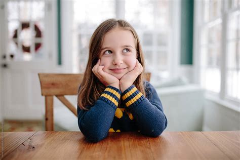 Cute Young Girl Smiling At Table Del Colaborador De Stocksy Jakob