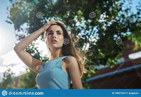 Beautiful Fashion Young Woman With Blowing Hair Posing In The City
