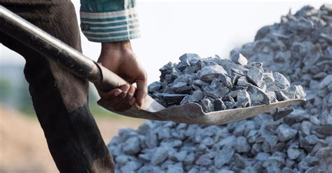 Worker Holding Rocks On Shovel · Free Stock Photo