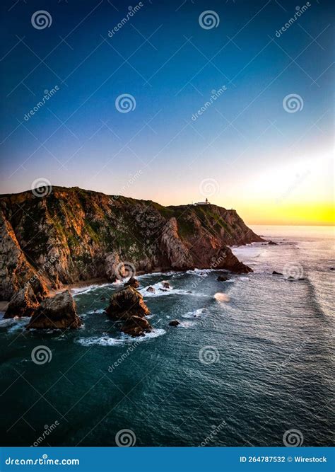 Scenic Vertical View Of The Rock Formations In Ursa Beach During A
