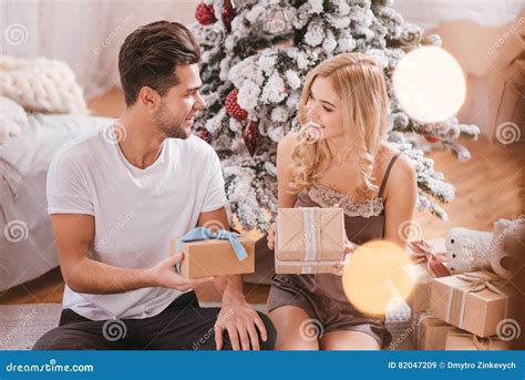 Delighted Happy Couple Enjoying Their Christmas Morning Stock Image