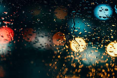 Rainy Night Traffic Lights Of Big City Rain Drops On Car Windshield