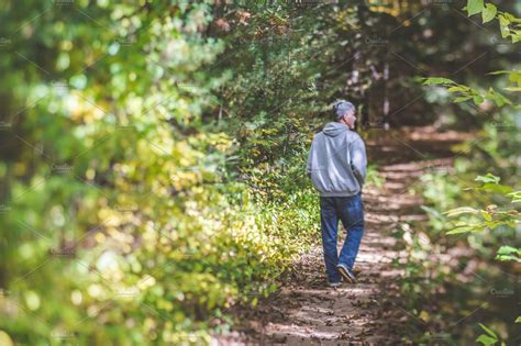 Man Walking On Path In Woods High Quality People Images Creative Market