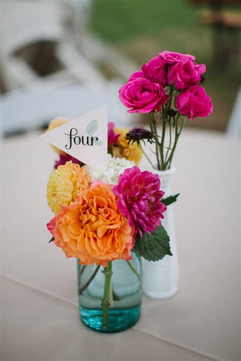 Table Number Flags With Hot Pink And Orange Centerpiece Florals Pink