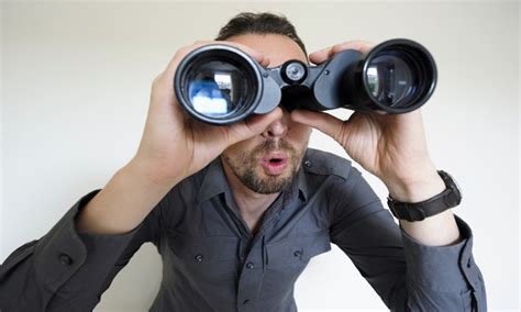Man Looking Through Binoculars 600×360