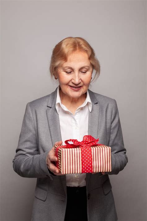 Cheerful Woman 60s Years Old Holding Red Gift Box Present Portrait