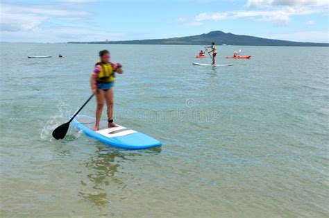 People Paddle Boarding In Mission Bay In Auckland New Zealand Editorial