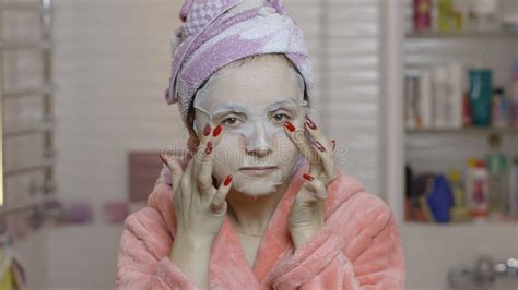 Woman Applying Cosmetic Face Mask In Bathroom Skincare Spa Facial