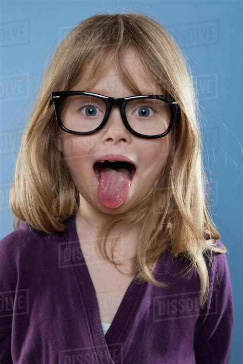 A Young Girl Sticking Out Her Tongue Playfully Studio Shot Stock