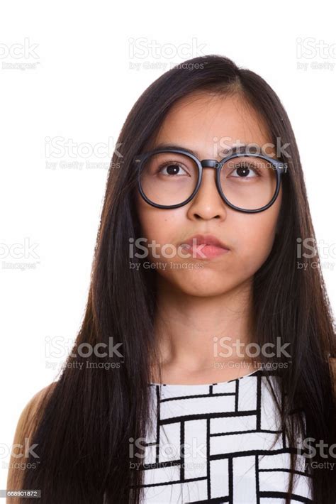 Face Of Young Asian Teenage Nerd Girl Thinking Stock Photo Download