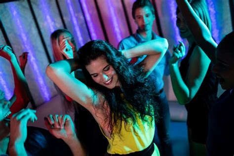 Premium Photo Group Of Smiling Friends Dancing On Dance Floor