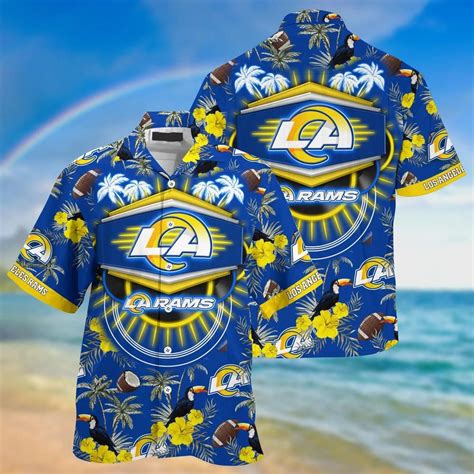 A Blue Shirt With The Los Rams On It And A Rainbow In The Sky Behind It