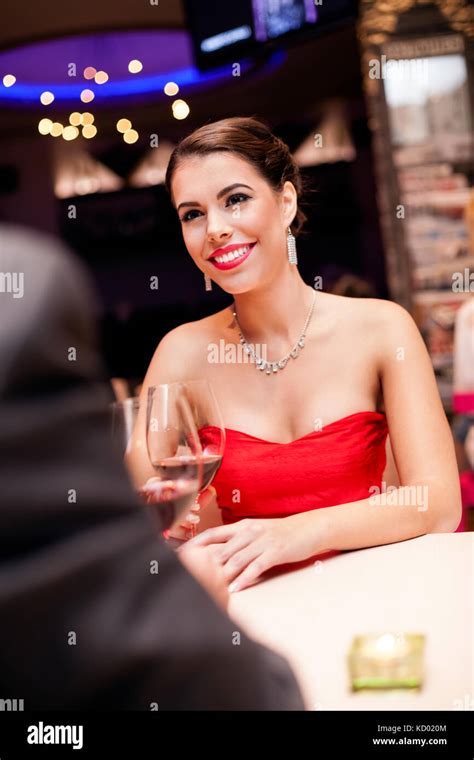 Beautiful Young Woman In Red Dress In Restaurant Stock Photo Alamy