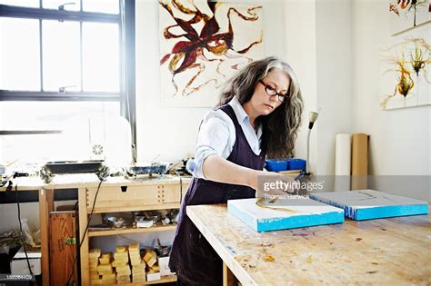 Female Painter Working On Painting In Studio High Res Stock Photo