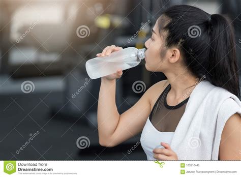 Fitness Woman Drinking Water From Bottle After Work Out In Fitness