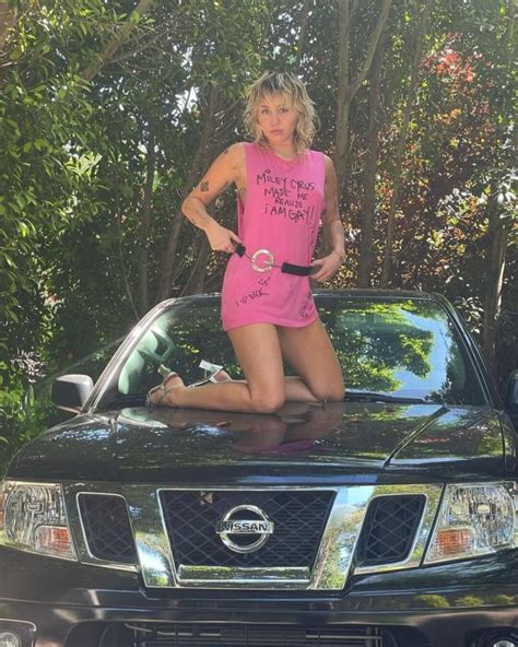 Miley Cyrus Poses On Dad Billy Ray Cyrus Truck In Nsfw Graphic Tee And No Pants