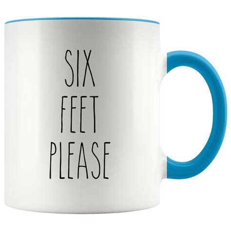 A Blue And White Coffee Mug With The Words Six Feet Please Printed In Black On It