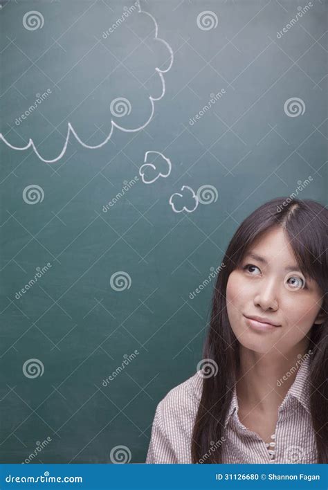 Thoughtful Young Woman With Thought Bubble On Blackboard Looking Up