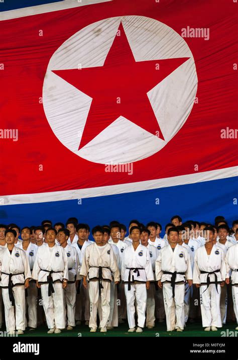 North Korean Taekwondo Team In Front Of A Giant Flag During The Arirang Mass Games In May Day