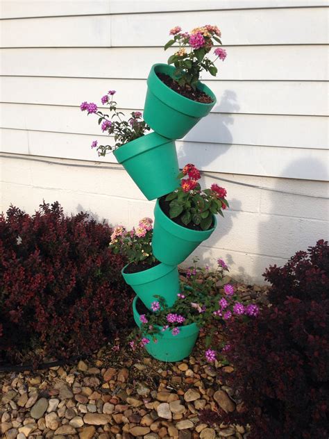 Three Green Flower Pots Are Stacked On Top Of Each Other