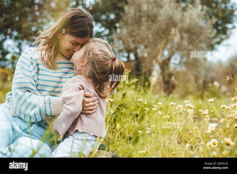 Happy Mother And Daughter Rubbing Noses In Meadow Stock Photo Alamy