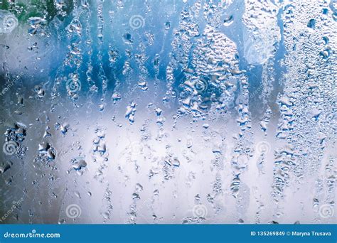 misted glass with water drops on blue background stock image image of condensation drips