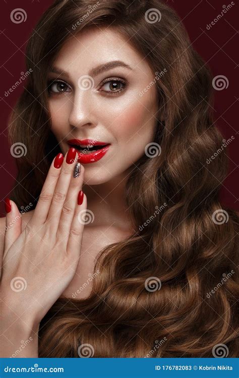 Beautiful Girl With A Classic Make Up Curls Hair And Red Nails Manicure Design Beauty Face
