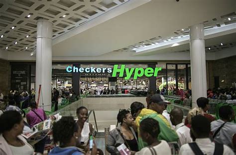 The Logo Of Supermarket Chain Checkers Hyper Is Seen As Customers Walk