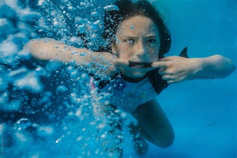 Young Preteen Girl Having Fun Swimming In A Pool Underwater By Stocksy Contributor Robert