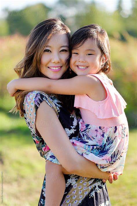 Happy Asian Mother And Daughter In A Park By Stocksy Contributor Take A Pix Media Stocksy