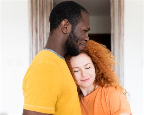 Free Photo Side Shot Of Interracial Couple Hugging