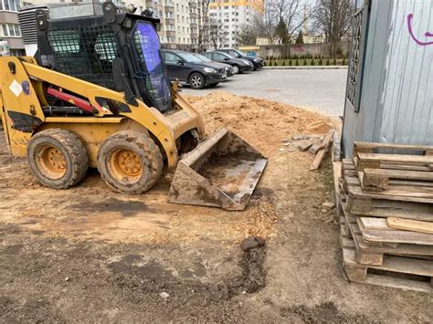 Mini Excavator Digging Earth In A Field Or Forest Laying Underground