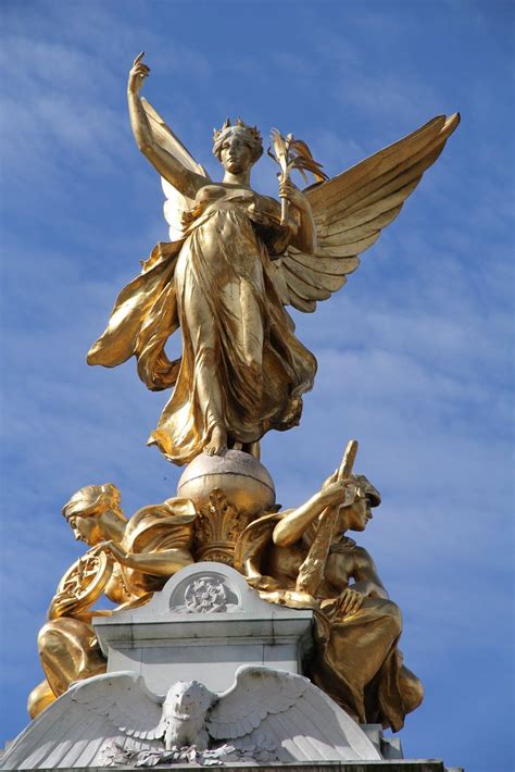 The Gold Painted Statue At The Top Of The Queen Victoria Monument