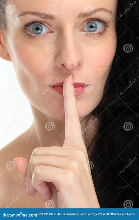 Attractive Brunette Woman Placing The Finger In Front Of Her Lips On White Background Stock