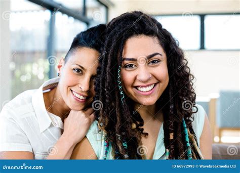 smiling lesbian couple relaxing on sofa stock image image of casual adult 66972993