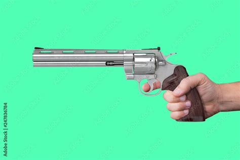 Hand Holding And Aiming A Gun On Isolated Green Screen Background