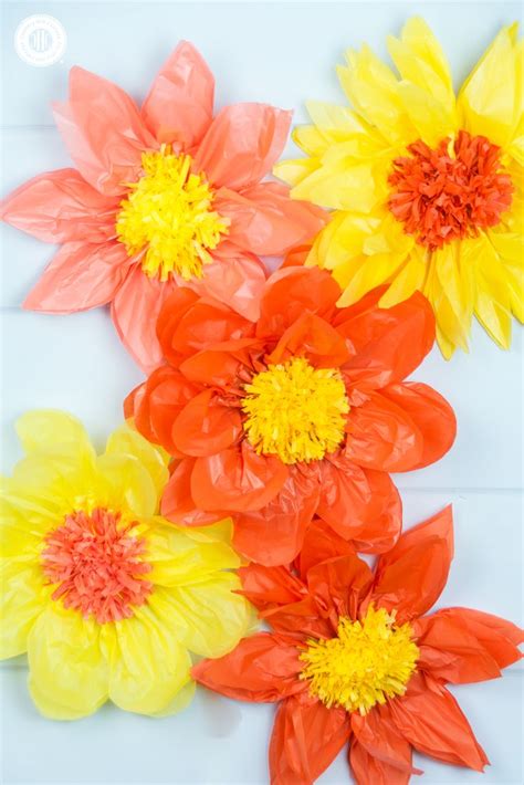 Paper Flowers Are Arranged On A White Surface With Yellow And Red