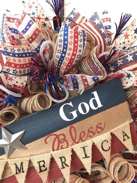 A Patriotic Wreath With The Words God Blessing America On It And Red