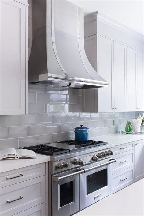 Subway tile offers tons of room for creativity in the kitchen. Gray Beveled KItchen Backsplash Tiles with French Hood - Transitional - Kitchen