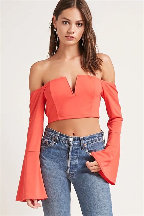 a knit crop top featuring an elasticized off the shoulder neckline with a plunging v wire and