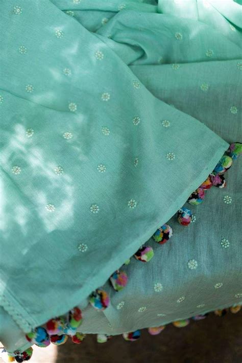 details saree mul cotton with self threadwork border sea green pom pom edging all around