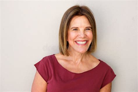 Close Up Beautiful Middle Age Woman Smiling Against White Wall Stock